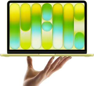 MacBook Neo in citrus colour, balanced on fingertips of open hand, screen displaying colourful abstract pattern