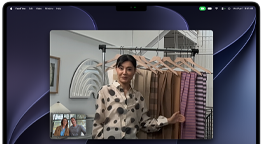 A video call on a MacBook Pro where a woman shows fabrics to two people on the call, with Center Stage keeping her centered in the frame as she moves around