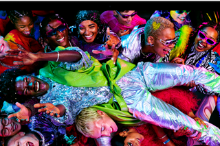 Colourful screen on a MacBook Pro of a person crowd-surfing at a party, showcasing the vibrant Liquid Retina XDR display