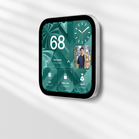 Apple HomeView wall-mounted model on a wall, silver color, displaying time, temperature, and controls for thermostat, bedroom fan, door lock, and lights