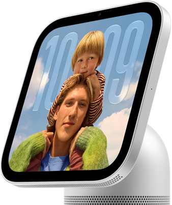 Apple HomeView, silver color, side exterior, semi-transparent time of day displayed on an image of a person carrying a child on shoulders, both looking forward