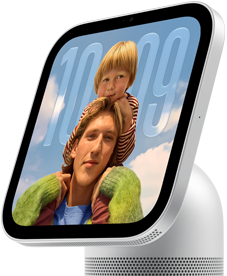Apple HomeView, silver color, side exterior, semi-transparent time of day displayed on an image of a person carrying a child on shoulders, both looking forward