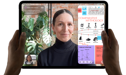 iPad Pro, front exterior, landscape orientation, space black colour, rounded corners, black display bezel, hands holding left and right sides, display showing a FaceTime conversation being live translated, and an educational app showing a presentation of “Comparative Mythology” with text, diagrams and handwritten notes