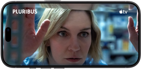 iPhone 18 Pro, landscape mode, displaying a close-up of a woman looking through a shelf. Series title: Pluribus