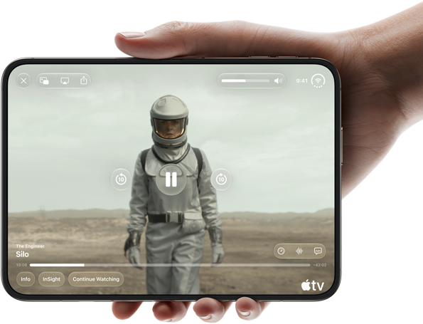iPhone Duo, held with one hand, opened in horizontal orientation, fully unfolded, interior screen displays Apple TV show “Silo”