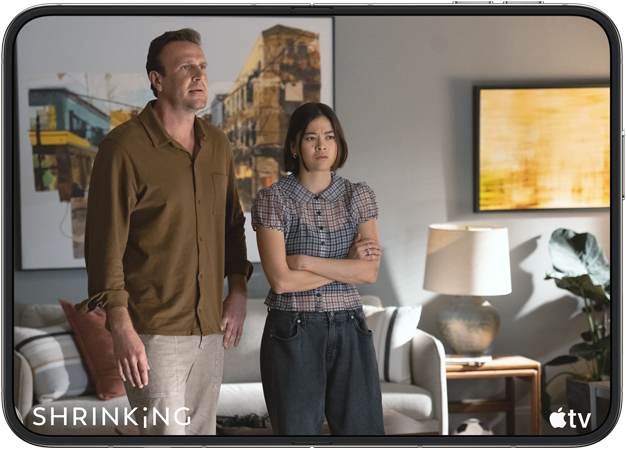 iPhone Duo, opened in horizontal position, Apple TV show “Shrinking” plays on screen