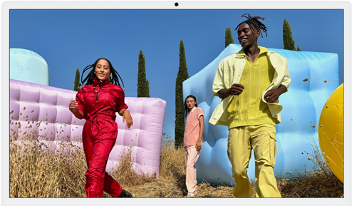 Three people in bright outfits, surrounded by colorful inflatable shapes