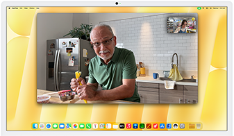 Desk View demonstration. Person on a video call watching top-down view of a baker decorating a cookie
