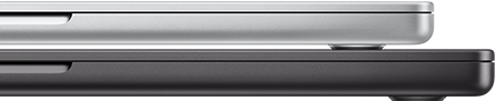 Closed 14-inch MacBook Pro in Silver finish, stacked on closed 16-inch MacBook Pro in Space Black finish