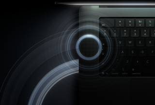 MacBook Pro with PROLED XDR Display, open lid, space black color, keyboard lit by glow from display, circles depicting sonic waves eminate from top and left side of laptop body