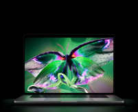 MacBook Pro with PROLED XDR Display, open lid, space black color, display shows detailed, high-contrast image with vivid colors, screen illuminates keyboard