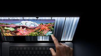 MacBook Pro with PROLED XDR Display, space black color, user resizes a window on screen with their fingertip