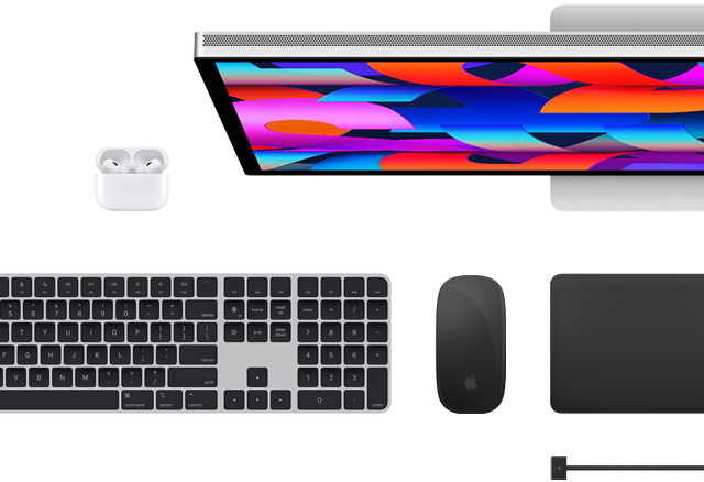 Top view of select Mac accessories: Studio Display, Magic Keyboard, Magic Mouse, Magic Trackpad, AirPods, and MagSafe charging cable
