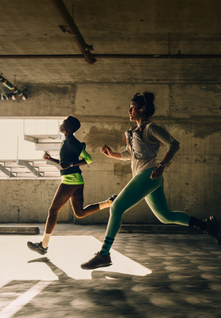 A group of people running in a city while wearing Apple Watch Series 12