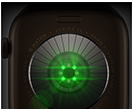 Back of Apple Watch Series 12, aluminium case, dark bronze colour, multiple round sensors with glowing green LED lights, left side exterior, Digital Crown, Sport Band, olive colour